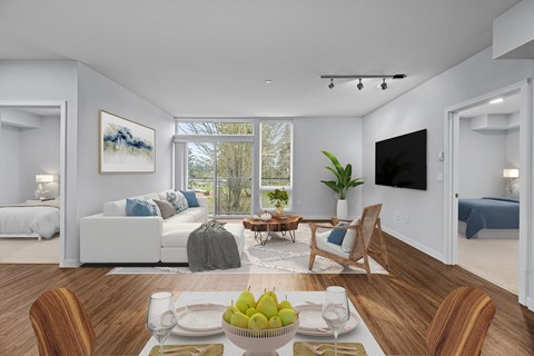 a living room with a couch and a table with a bowl of fruit